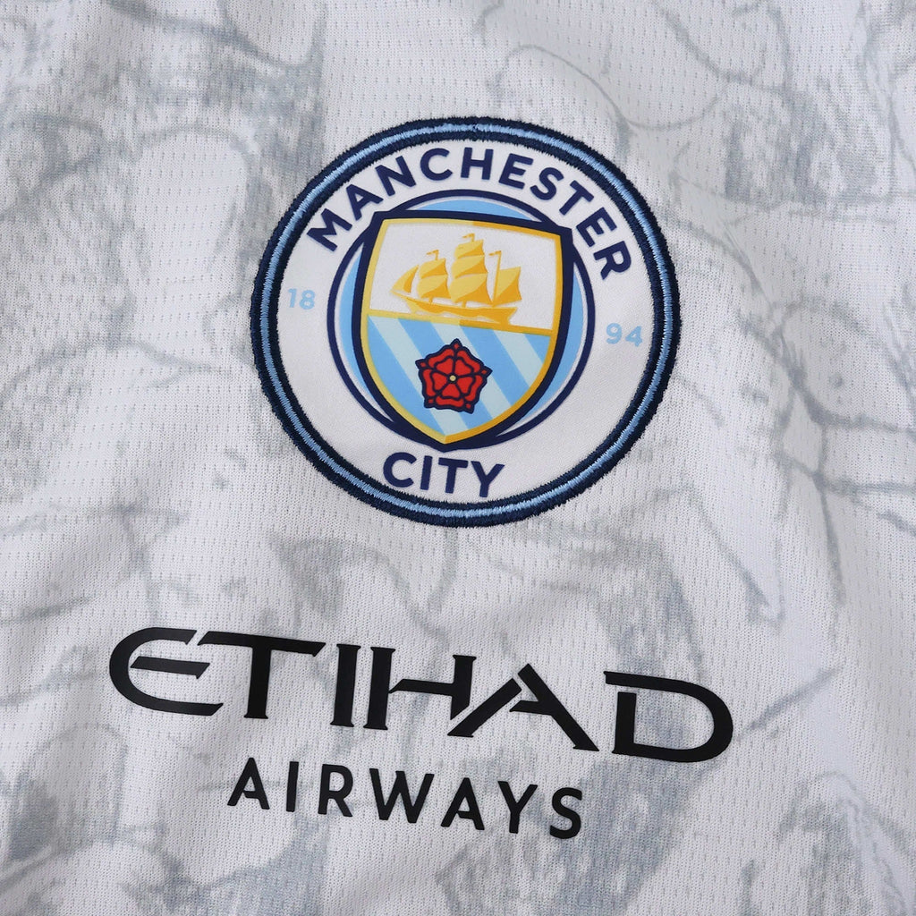 Manchester City 25/26 x KidSuper Jersey - crest and sponsor detail