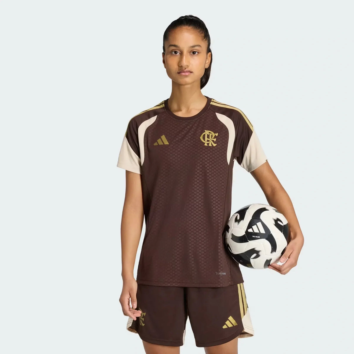 Flamengo 2026 women's training jersey in brown with cream sleeves and gold crest, worn by model